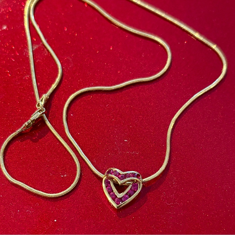 Buy your honey a valentine gift. Lovely heart necklace with red colored stones.